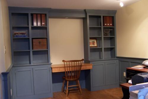 Custom made home office with bookshelves,desk, and cabinets.